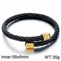 Twisted stainless steel cable bracelet in black with gold accents and size specs - Black & Gold