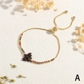 Detail of adjustable gold bee bracelet with colorful gemstones and slider clasp closure - Bee (BR1758-A)