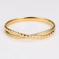 Polished gold knotted bangle featuring pyramid stud texture and a smooth mirror finish - Gold