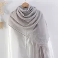 Pale purple crinkled cotton linen scarf with frayed edges hanging on a wooden hanger - Lavender Grey
