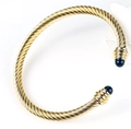 Detail of twisted cable gold bracelet with black round beads on both open ends - Gold-Black Bead
