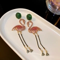 Detailed view of luxury flamingo earrings with pink rhinestones and gold tassels - Pink-Silver Pin Rhinestone Flamingo Earrings
