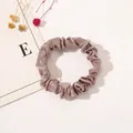 Close-up of pink satin hair scrunchie showing smooth texture and elegant pleats - Satin Thin Scrunchie-Nude Pink