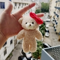 Beige teddy bear plush keychain with a red bow and silver chain link strap - Bear with Bow