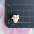 Detailed view of a 1.5cm miniature resin cupcake charm with pink sprinkles and cream topping - Yellow Bowl Two Scoops Ice Cream