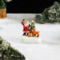 Detail of resin Santa Claus and reindeer figurines with glowing star tree on snow base - Santa & Reindeer