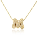 Close-up of gold box chain necklace with a crystal-encrusted letter M pendant - Letter M