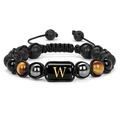 Close-up of handmade 10mm lava rock and tiger eye bead bracelet with golden letter W - Style W