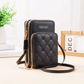 Detailed view of black quilted crossbody phone bag with triple zippers and logo - Black