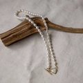 Elegant freshwater pearl necklace with gold heart-shaped OT buckle on rustic wood base - Heart Mabe OT Clasp Rice Pearl Necklace