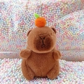 Brown capybara plush keychain with orange topper on colorful bubble foam background - Dark Brown Orange + Bead Chain