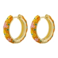 Macro detail of colorful enamel camellia earrings with vibrant orange and gold accents - Gilded