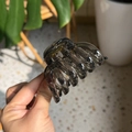 Detail of smoky gray translucent pumpkin hair claw clip held by hand in home setting - Medium(Approx 7cm) / Transparent Black
