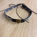 Close-up of a brown leather hat band featuring white stitching and a bronze sun pendant - 56-58cm / Dark Brown and Bronze Sun Pattern Choker (AB305)