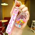 Close-up of pink acrylic candy-shaped keychain with colorful sequins and a metal ring - Lollipop String [colorful] Glow-in-the-dark Bubble Bead Candy