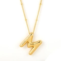 Polished gold bubble letter M necklace with sunburst engraving on a white background - Gold - M