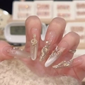 Luxurious almond nails with gold snake, butterfly charms and pearls in glossy nude finish - Golden Abundance (BY2199)