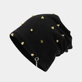 Detail of black knit beanie with gold cone studs and a silver metal ring accent - Gold Rivet