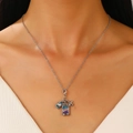 Silver travel charm necklace with camera airplane and suitcase pendants on a model - Camera Airplane Suitcase Necklace (7467) / Silver