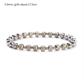 Detailed macro view of 5mm silver and gold beaded stretch bracelet with grid texture - 5mm Bead Diameter / Gold + Silver