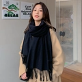 Close-up of thick black wool scarf with fringes worn with a camel coat in outdoor setting - Black