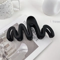Matte black oversized wave hair claw clip for thick hair shown on aesthetic background - 13cm / Black