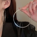 Close-up of oversized silver metal hoop earrings worn by a model for a modern look - Minimalist Atmospheric Silver Style (30#)