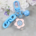 Detail of blue metal bell and acrylic smiley flower charm on colorful keychain - 5126-8 Blue Flower