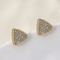 Macro detail of triangle zircon stud earring in gold plating with pavé setting details - Full Zircon Triangle (019)