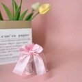 Pink organza drawstring gift bag featuring a large decorative satin ribbon bow - Pink