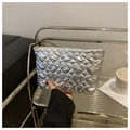 Close-up of silver quilted heart cosmetic bag with glossy finish and gold zipper - Silver