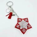 Detail of red star keychain with rhinestones, tassel decoration and silver bell - Snowflake