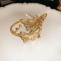 Close-up of golden hollow butterfly metal bracelet on elegant white relief porcelain plate - Gold Double Butterfly Style (HB2500)