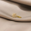 Macro shot of gold floral nose cuff with shimmering cubic zirconia on soft silk background - Six-Petal Flower (E3616-2)
