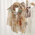 Floral print voile scarf in cream with green and orange leaves on a wooden hanger - Beige Green Orange Yellow Floral