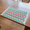 Rectangular woven table mat with red and green geometric patterns and white tassels - Red Green Wave Rhombus