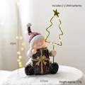 Mini Weihnachtsfigur Junge mit Baum und Geschenkbox aus Harz, Höhe 15cm Deko - Weihnachtsbaum in sitzender Pose (Leuchtend)