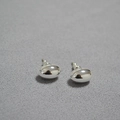 Minimalist silver mirror polished oval stud earrings on a grey textured fabric background - Silver Large