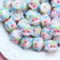 Iridescent DIY round beads with embossed floral patterns in pink, blue, and green colors - White Bead Blue Flower Cherry