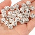 Close-up of silver hollow crystal balls with rhinestones for DIY jewelry making - Yangmei Ball Silver White Rhinestone