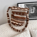 Close-up of the striped plush faux shearling fabric texture on this bucket bag - Diamond Brown Plaid