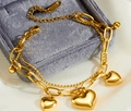 Macro shot of double-layer titanium heart charm bracelet on premium velvet jewelry box - Gold Double Layer Three Hearts
