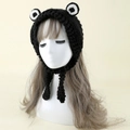 Detail of hand-knitted black frog beanie featuring large eyes and thick crochet texture - One Size / Black
