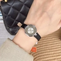 Elegant women's watch with silver round dial and black leather strap on a wrist - Silver Case Black Strap