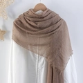 Khaki pleated cotton linen scarf with frayed edges displayed on a wooden hanger - Khaki