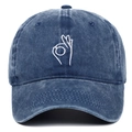 Detailed macro view of white OK hand gesture embroidery on navy washed cotton baseball cap - Adjustable / Navy Blue
