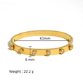 Detail view of 18K gold plated stainless steel bangle with 61mm inner diameter and 6mm width - Round Zirconia Style (HF-B5110-G)