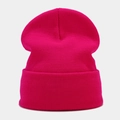 Close-up of ribbed knit texture on a vibrant magenta winter beanie with folded cuff - Rose Red