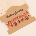 Detail of red bohemian hand-woven bracelets with faceted beads and natural stone on cards - Red Jasper