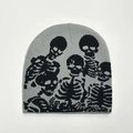Detail of knitted beanie showing the intricate black skull jacquard pattern on grey fabric - One Size / Gray